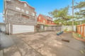 driveway and garage behind home